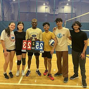 An intramural volleyball team poses for a picture after a win.